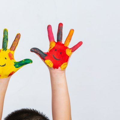 The hands of the child who smeared on the gray background.